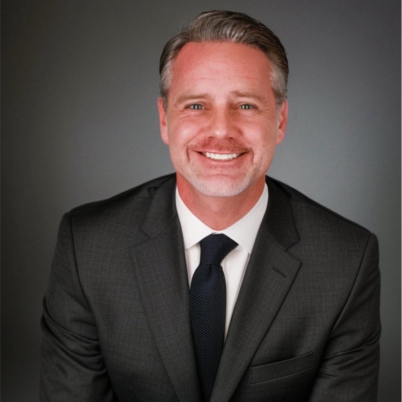 Headshot of Jeffrey N. Downing in professional attire smiling.